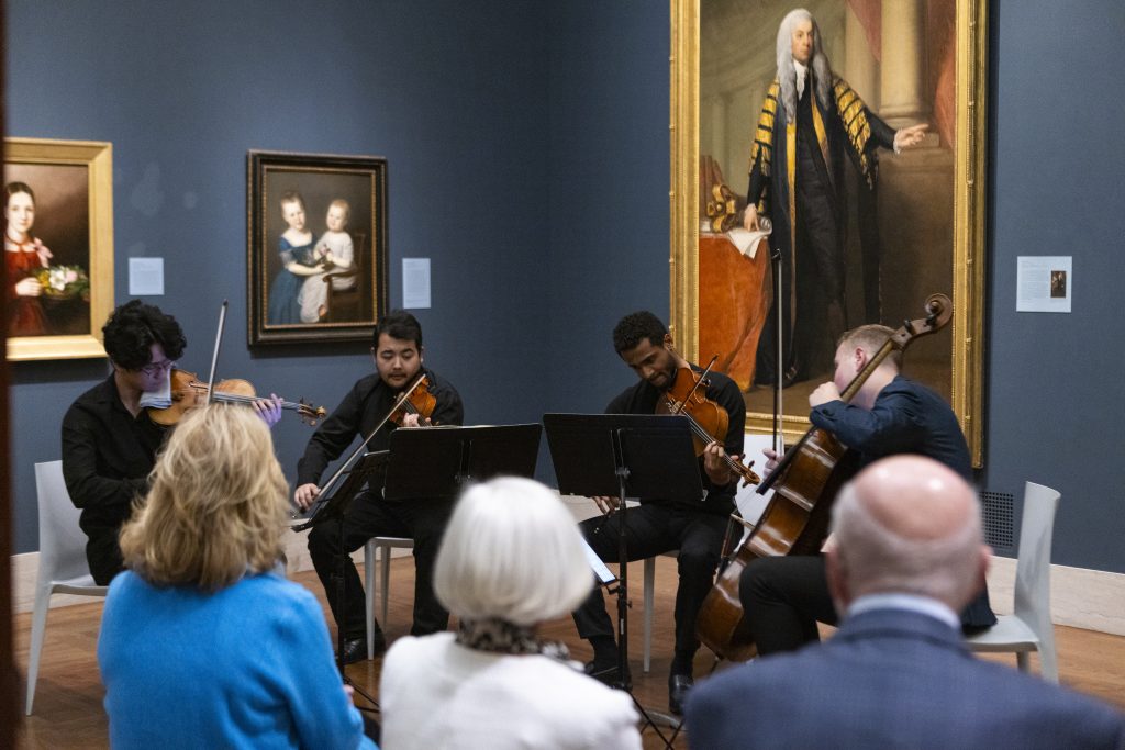 Society of Fellows members enjoy a live in-gallery performance by concert musicians.