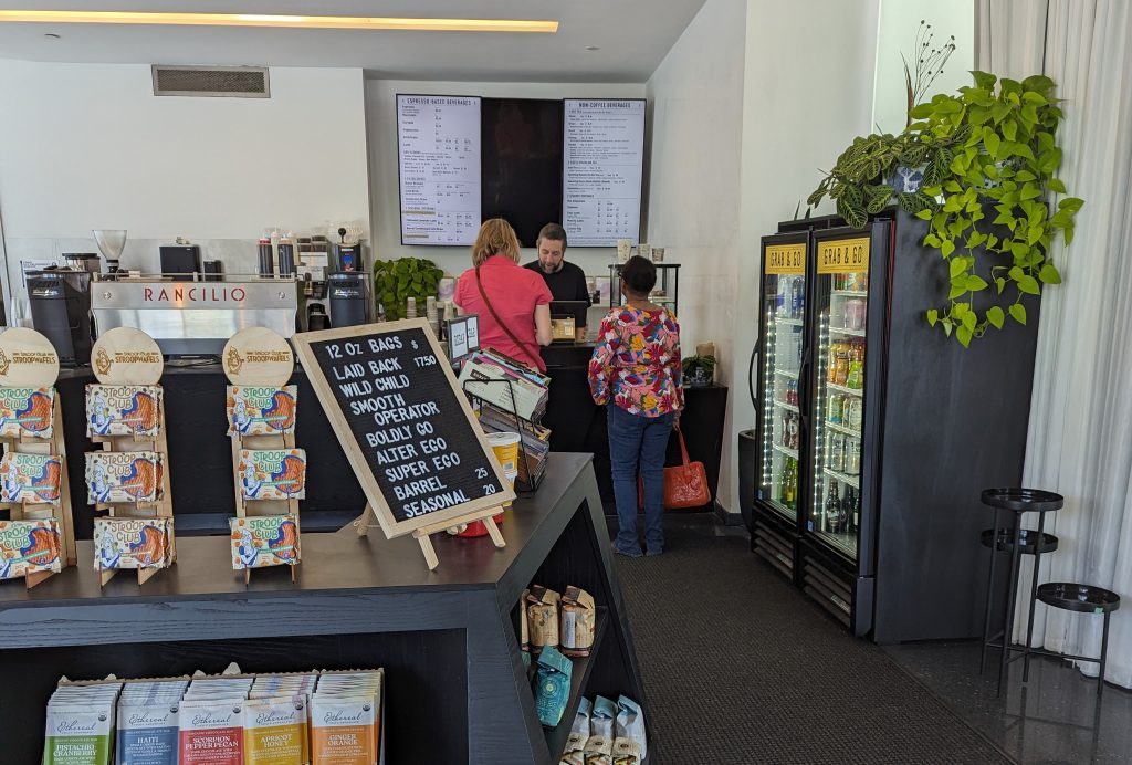 An image of two customers standing in front of the coffee ordering table