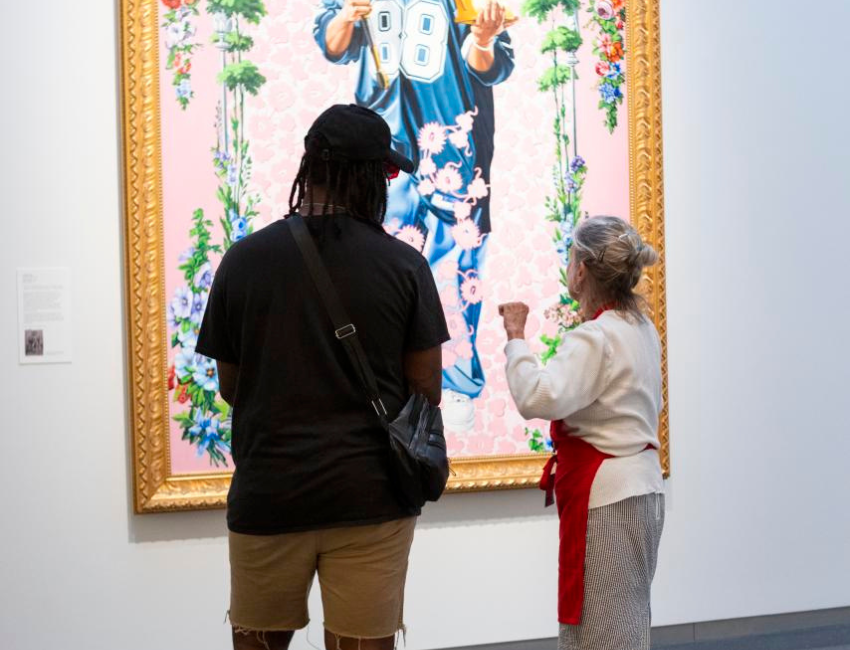 Two people looking at art in the gallery