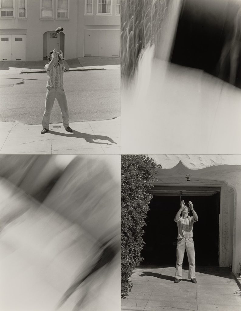 Photograph of man tossing juggling balls in the air