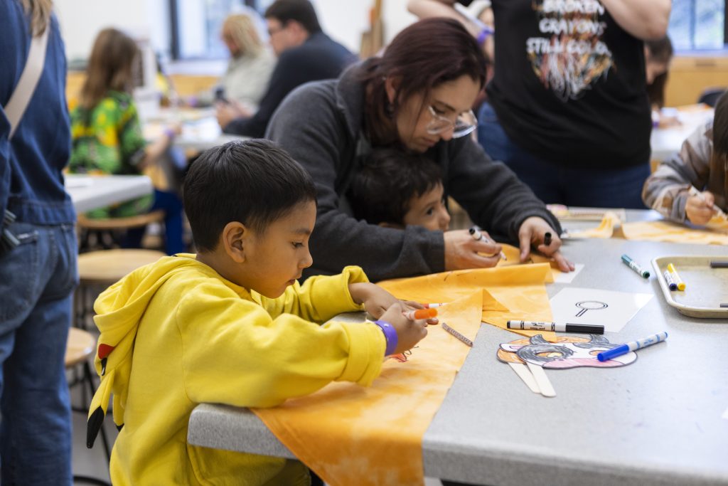 People work on art activities at a table during an event at The Nelson-Atkins Museum of Art.