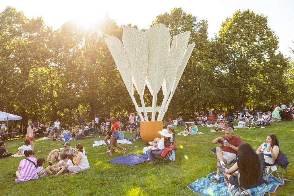 Guests gather on the south lawn of the Nelson-Atkins near Shuttlecock #3.