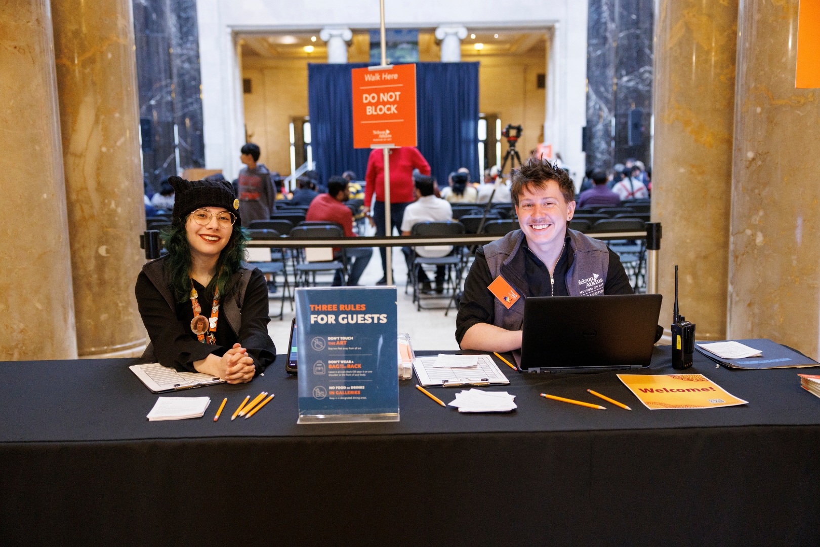 Two museum visitor officers smiling at a table