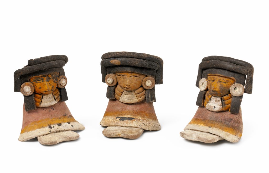 Three feminine figures of identical color and shape seated