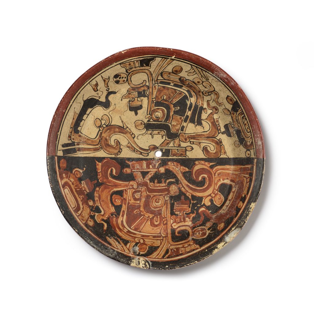 A plate with red and brown images painted across