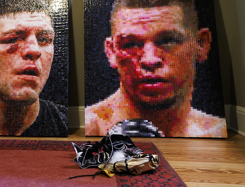 A photo of a wrestling mask in front of art featuring boxers