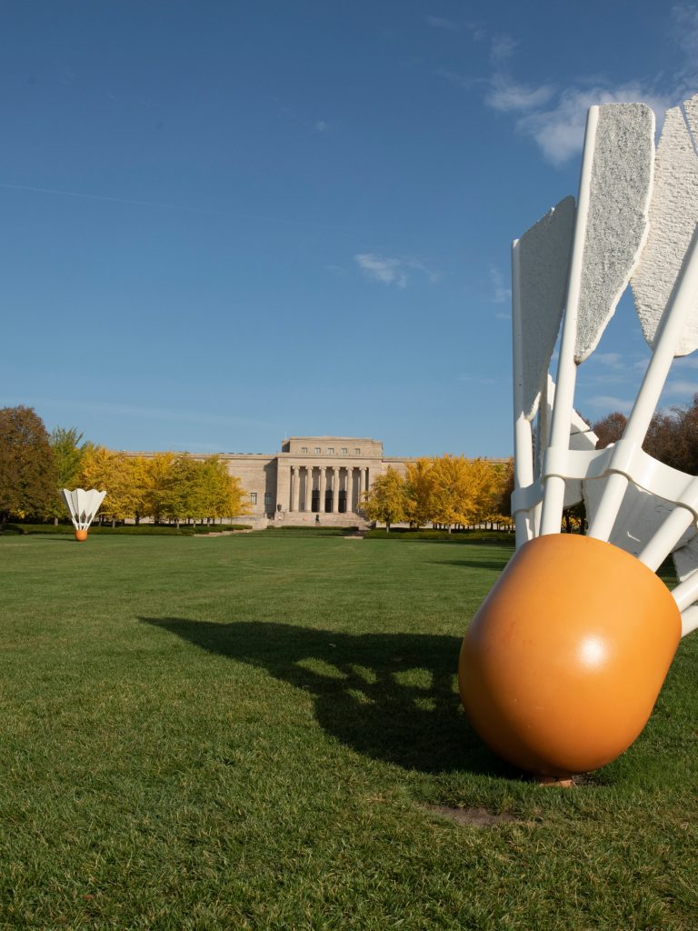 A picture of the Nelson-Atkins building from the south lawn with one of the giant shuttlecock statues in the foreground.