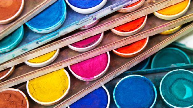 Colored pencils layed out over a drawing on paper.