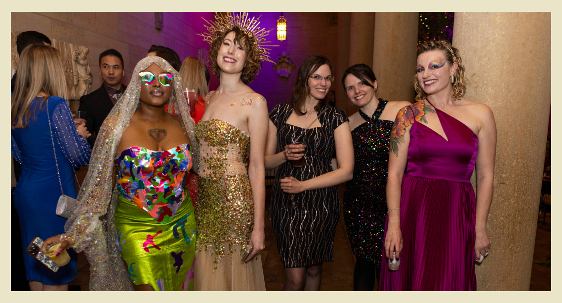 An image of the previous year's party arty attendees dressed up in themed, sparkling gowns of colorful designs. 