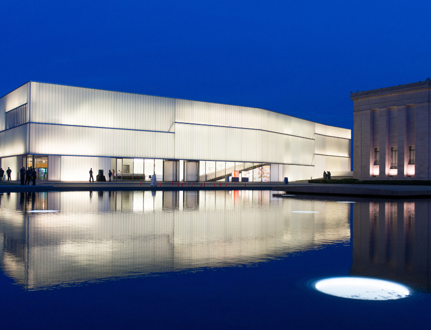 Photo of the bloch building lit up at night.