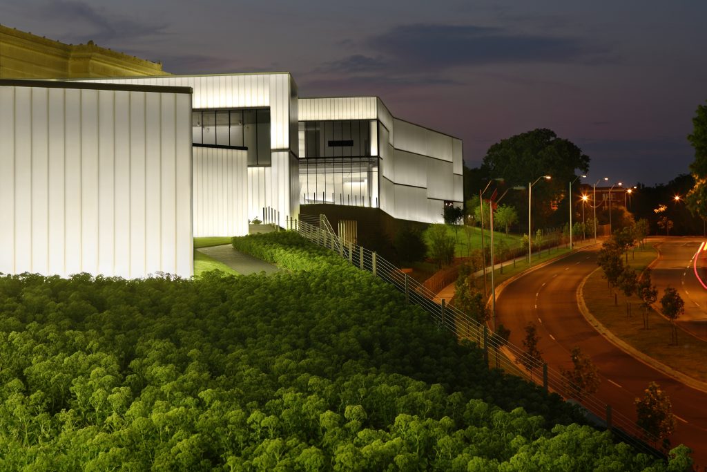 Photo of Bloch Building lit up at night.