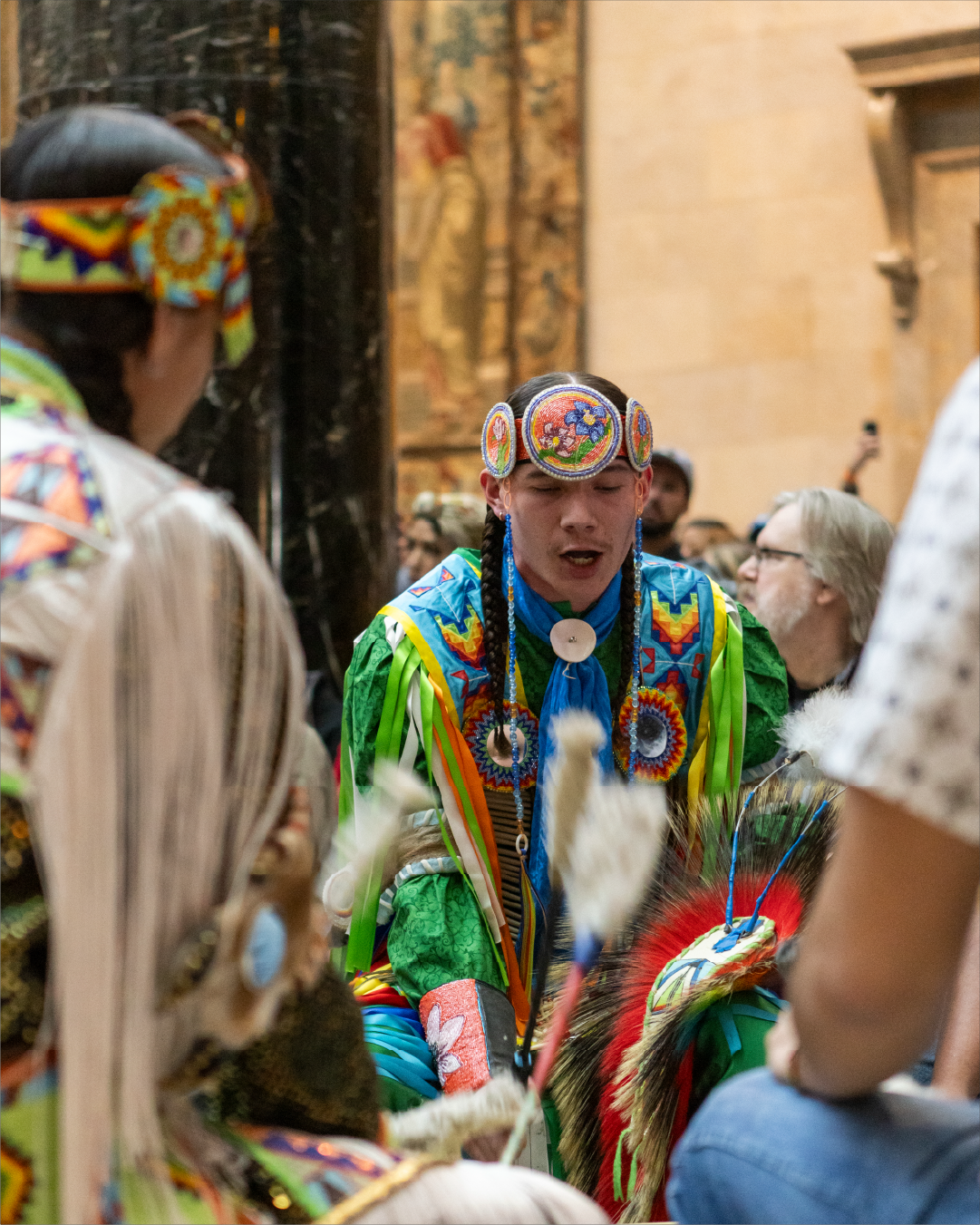 A performer sings while in colorful traditional garb
