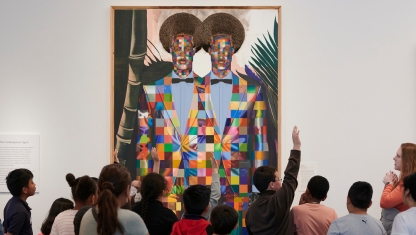 Art supplies ranging from scissors to colored pencils in varius cans.