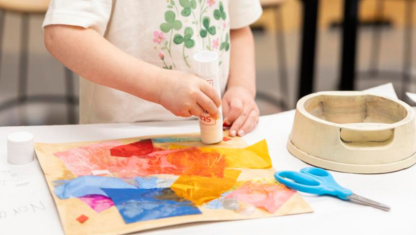 Art supplies ranging from scissors to colored pencils in varius cans.