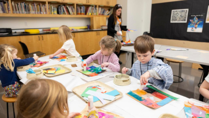 Art supplies ranging from scissors to colored pencils in varius cans.