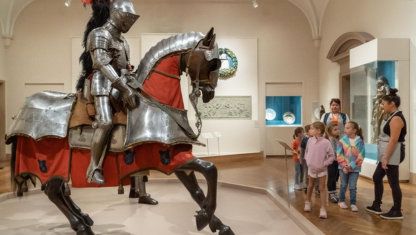 Colored pencils layed out over a drawing on paper.