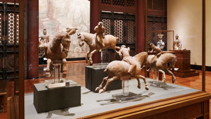 Art supplies ranging from scissors to colored pencils in varius cans.