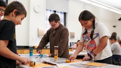 Colored pencils layed out over a drawing on paper.