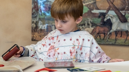 Art supplies ranging from scissors to colored pencils in varius cans.