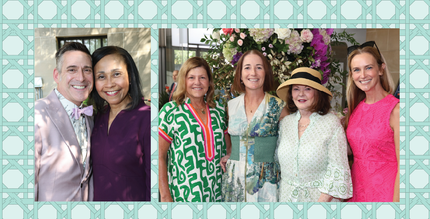 A group of c100 attendees standing in front of florals