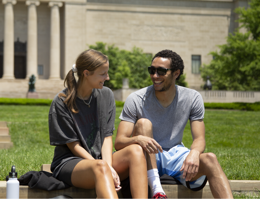 Two members smiling on the lawn of the Sculpture Park